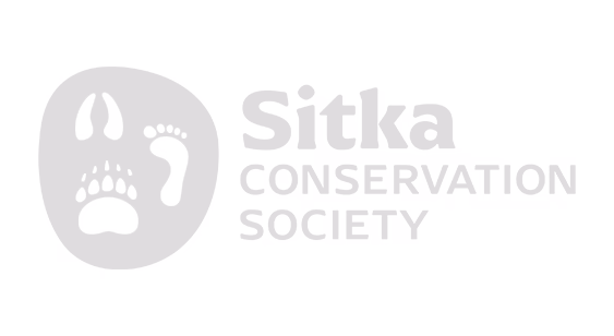 Sitka Conservation Society logo featuring animal paw, hoof, and footprint icons inside a rounded shape.