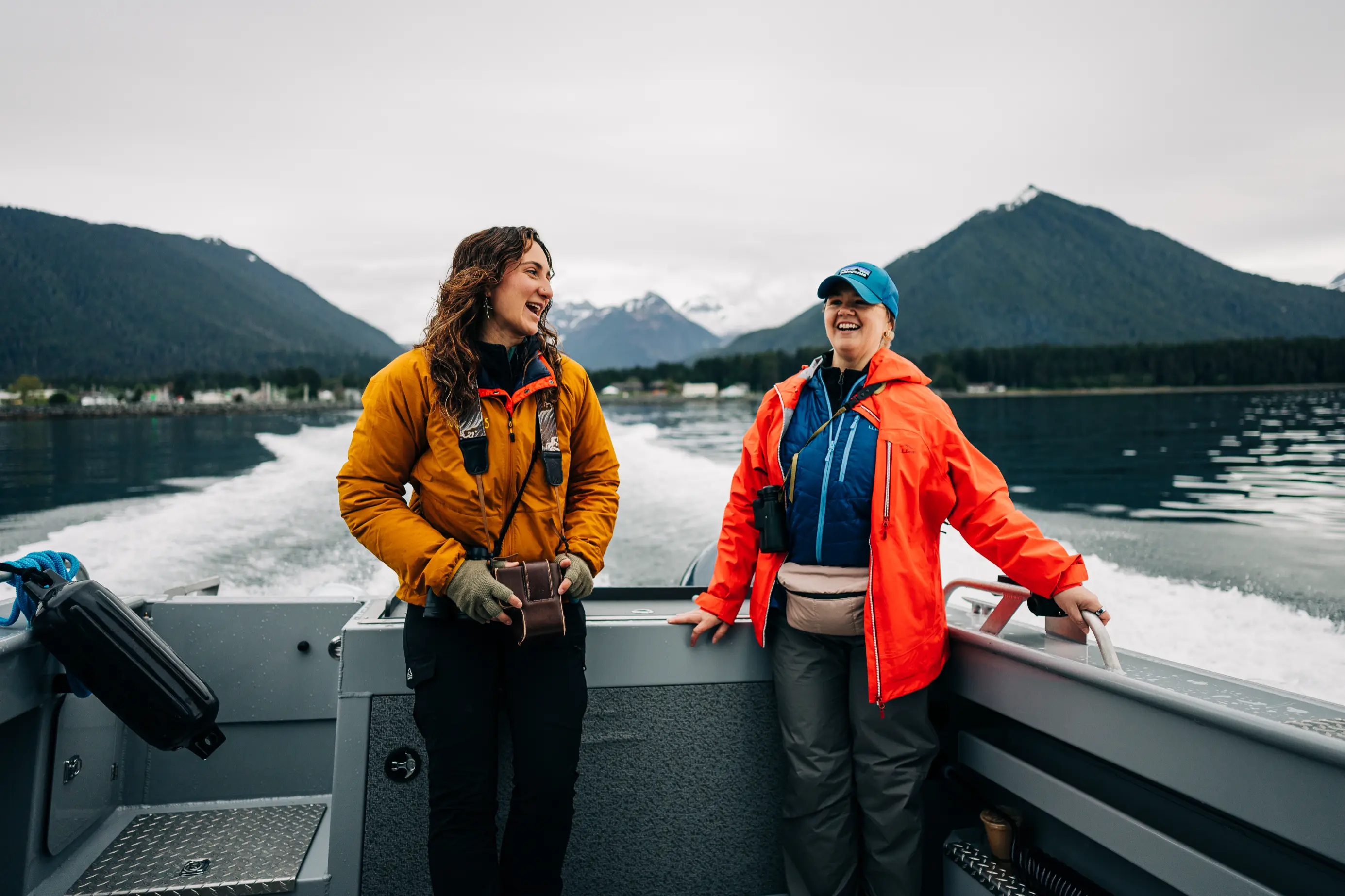 Naturalist guide talking with guests on a boat in Sitka Sound