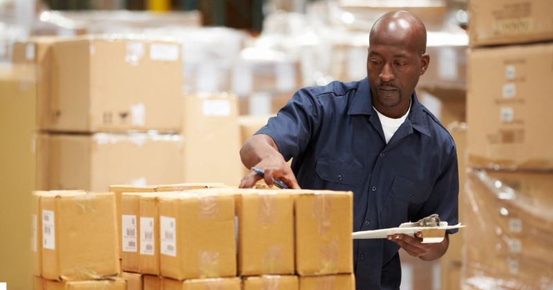 a warehouse worker checking boxes