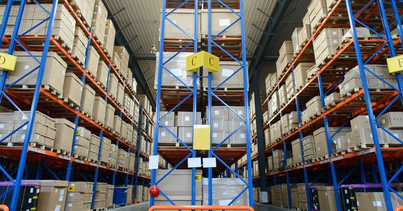 a tidy warehouse with tall shelves packed with boxes