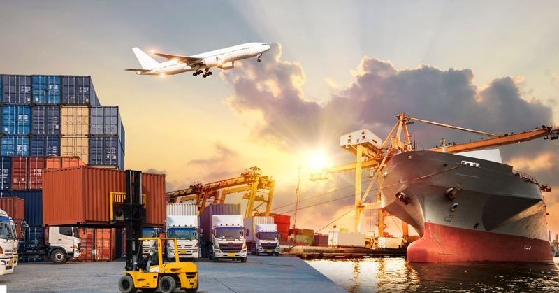 a busy port at sunset with various modes of transport