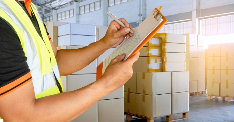 a warehouse worker holding order list