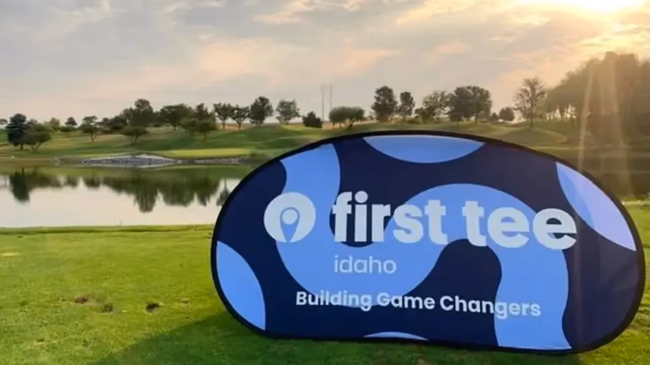 First Tee Idaho signage overlooking a beautiful golf course at sunset.