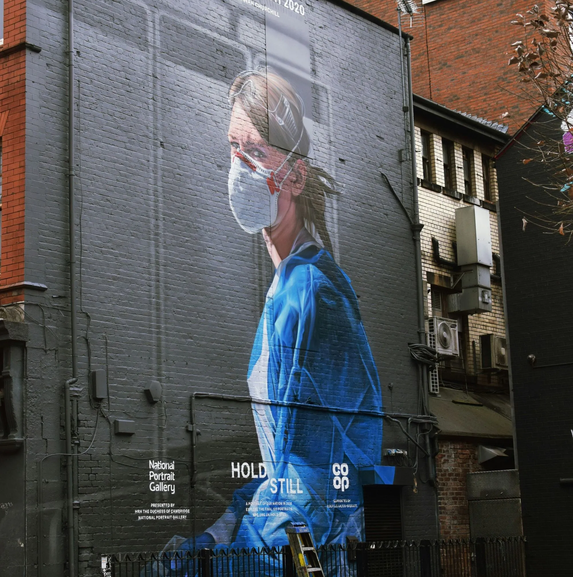 A mural picture of a nurse and her mask on a wall 