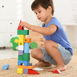 A child with a box of building blocks.