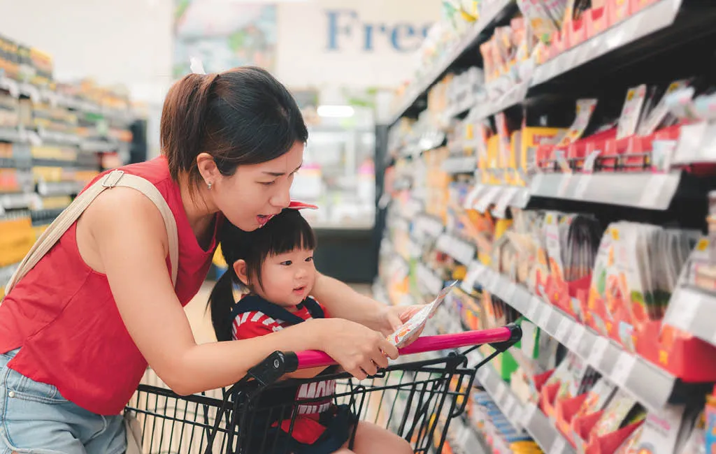 Mother and child buying fresh fruit at a farmers’ market.