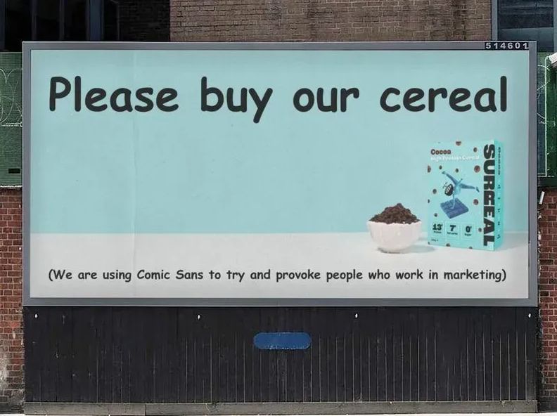 Outdoor billboard reading “Please buy our cereal” written in Comic Sans, with a Surreal cereal box and bowl of cereal on the right. Smaller text below jokes: “We are using Comic Sans to try and provoke people who work in marketing.”