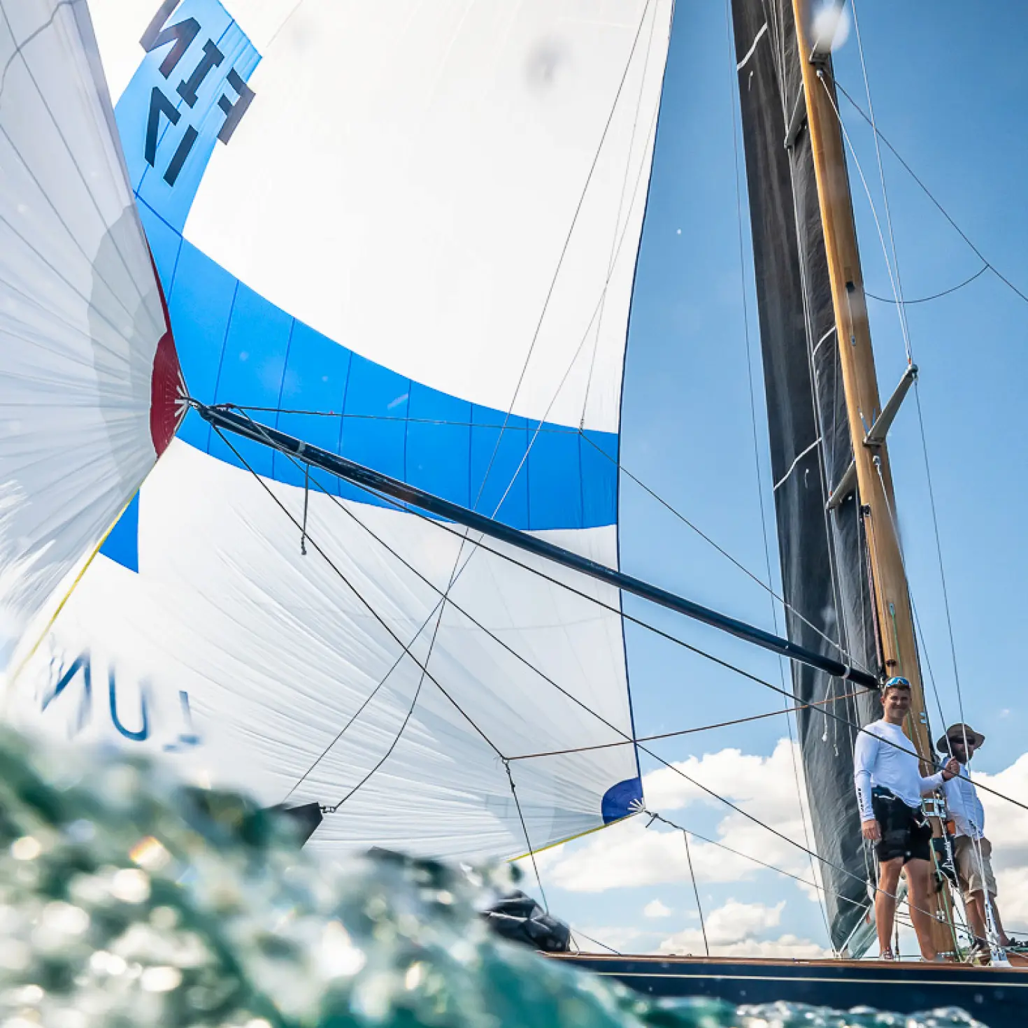 there are two people on a sailboat in the ocean