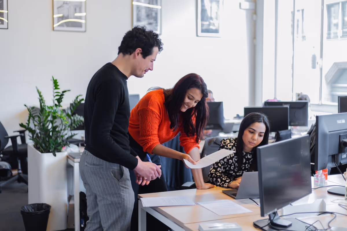 Happy Employees looking at Paper Happy Employees looking at Paper Normal