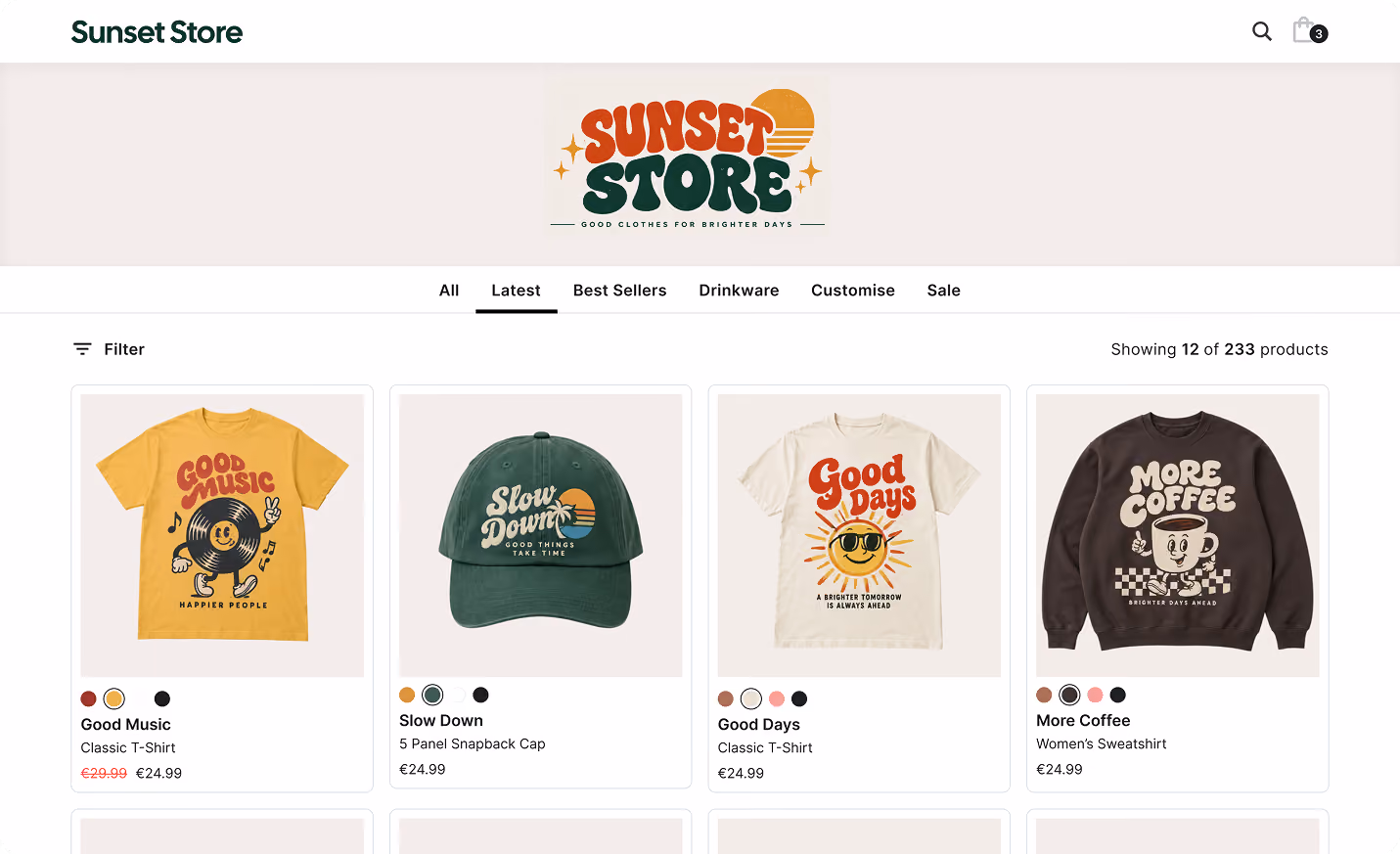 Screenshot of an online store called Sunset Store featuring a logo with a sun and the tagline 'Good Clothes For Brighter Days.' The page shows navigation tabs including All, Latest, Best Sellers, Drinkware, Customise, Sale, and a filter option. Four products are visible: a yellow 'Good Music' T-shirt with a smiling music note, a green 'Slow Down' 5-panel snapback cap, a white 'Good Days' T-shirt with a sun wearing sunglasses, and a black 'More Coffee' women's sweatshirt. Prices and color options are shown beneath each item.