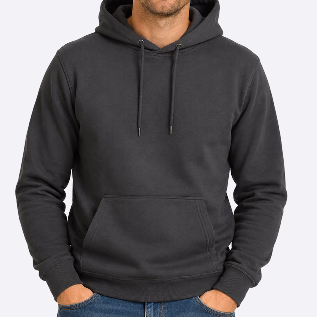 Man wearing a plain black hoodie with a front pocket and drawstrings, paired with blue jeans.