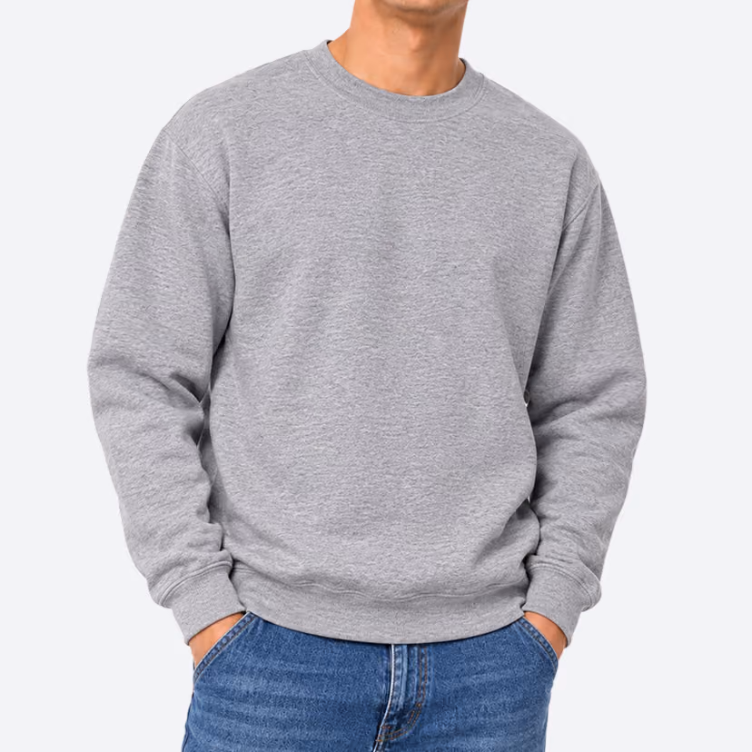 Person wearing a plain light gray crewneck sweatshirt and blue jeans with hands in pockets, shown from neck to hips.