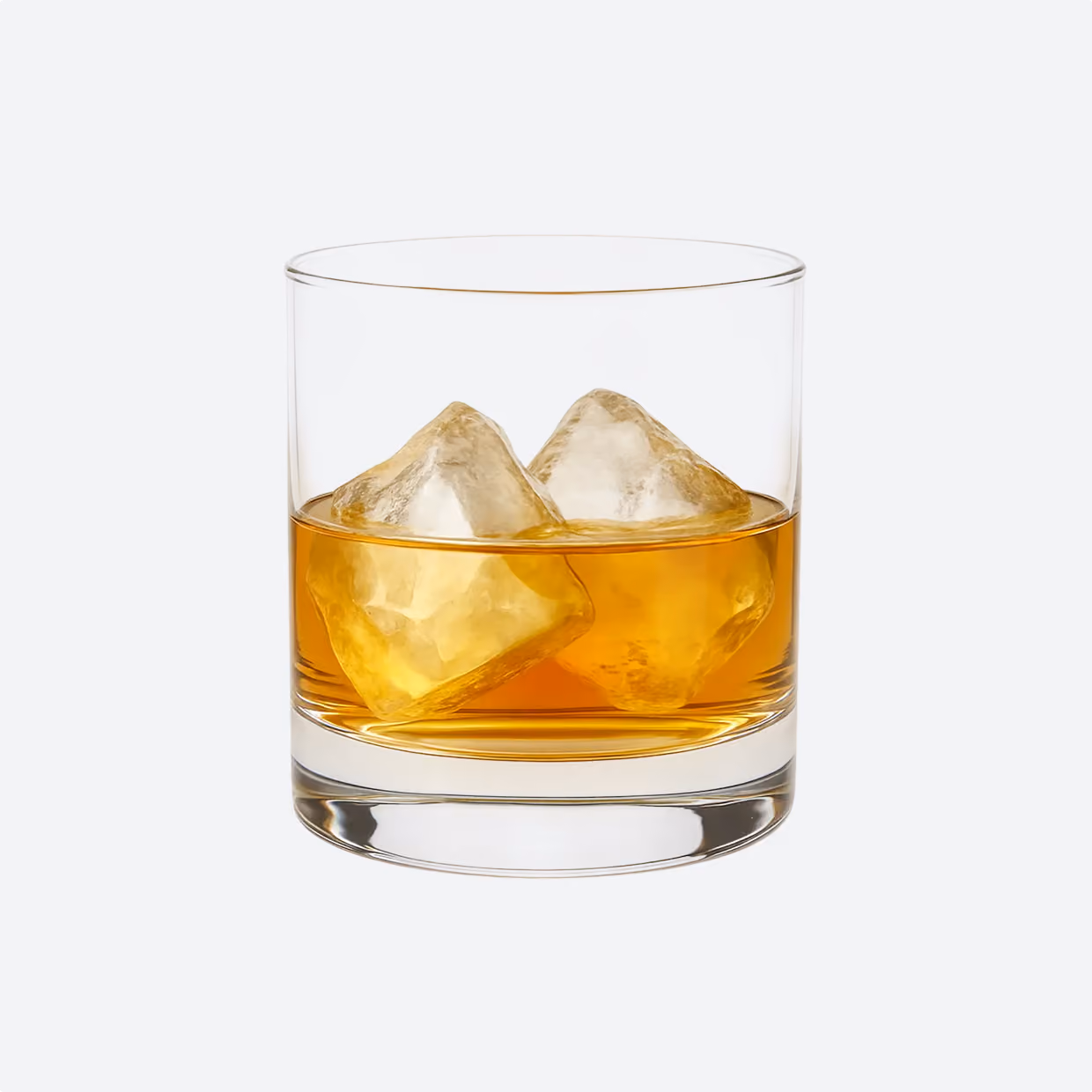 Clear glass with two large ice cubes and amber-colored whiskey inside, set against a light gray background.