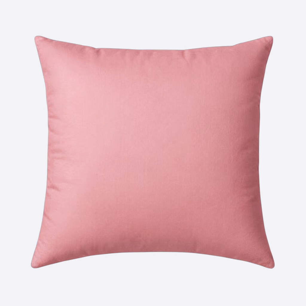 Square pink cushion with a smooth fabric texture on a plain light background.