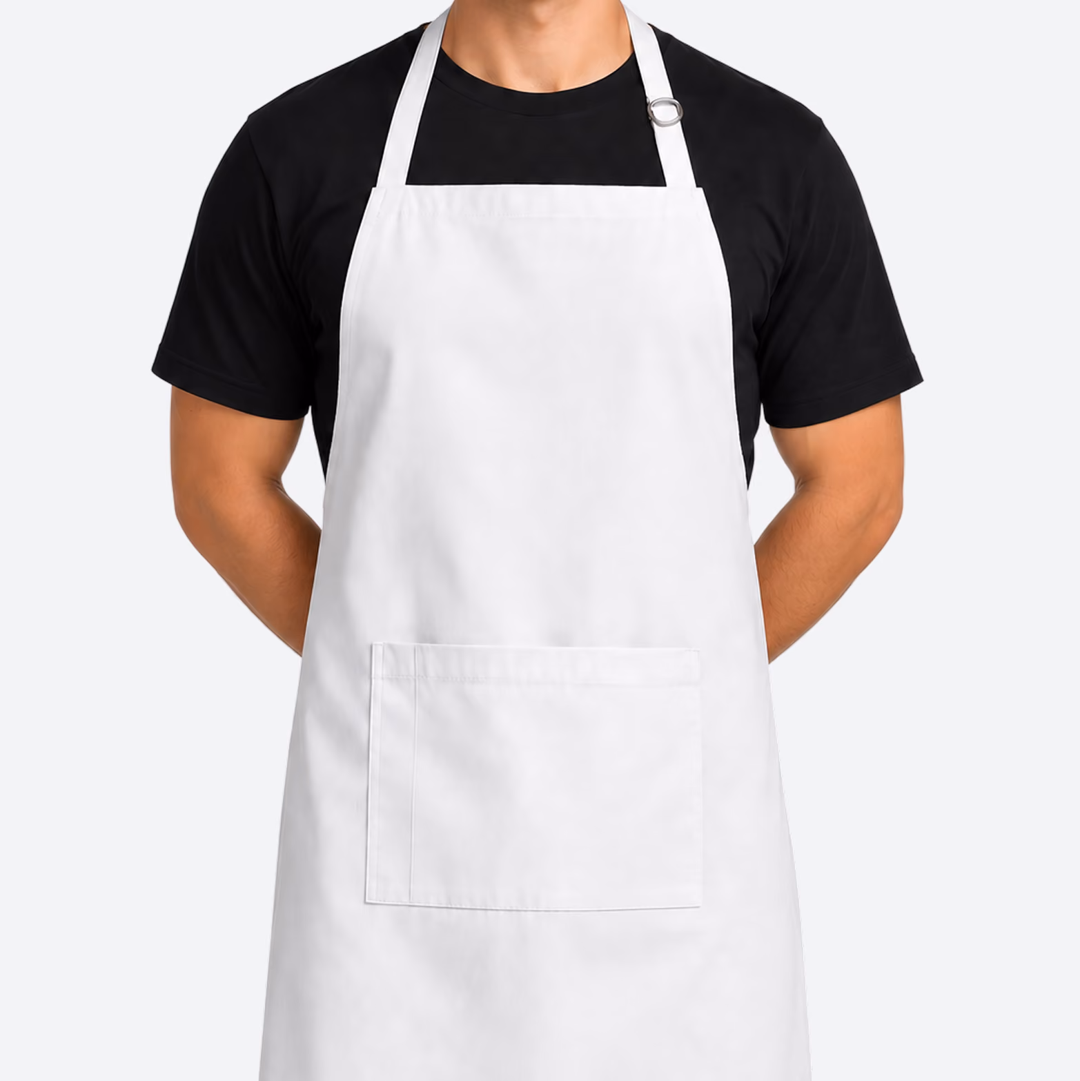 Person wearing a plain white apron over a black short-sleeve shirt, with a front pocket and adjustable neck strap.