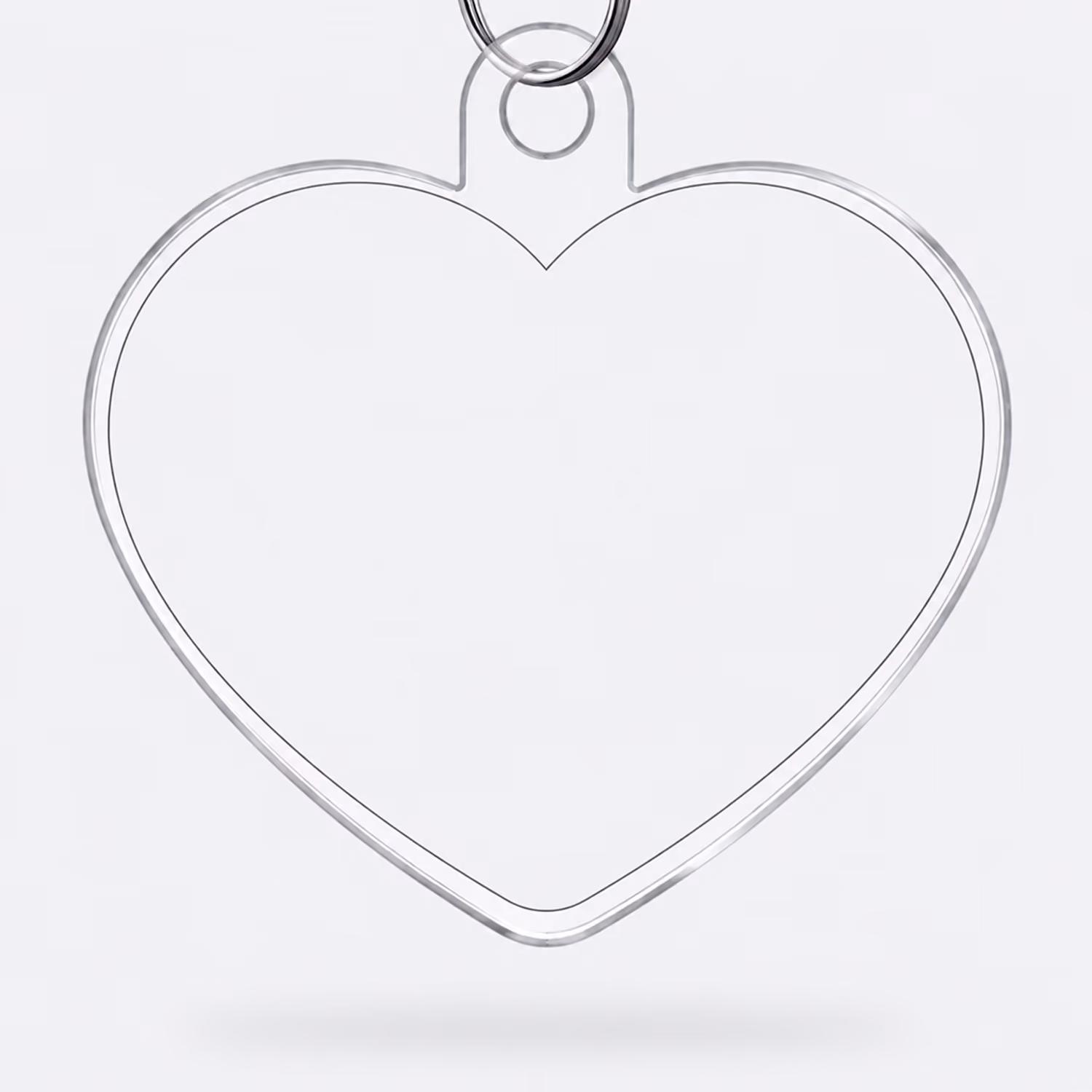 Clear, transparent heart-shaped keychain with a metal ring attached at the top.