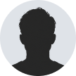 Silhouette of a person with short, curly hair on a light gray circular background.