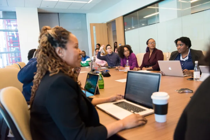 A group of diverse people meeting at a table.