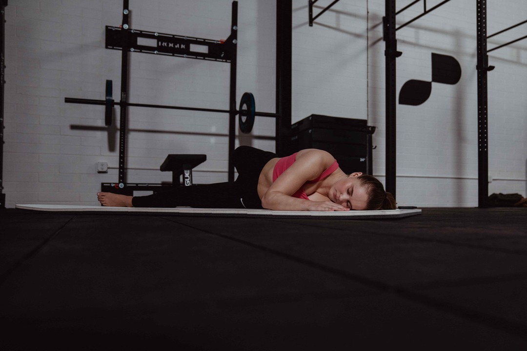 Woman Working out on Yoga mat - Muscle Soreness vs Injury