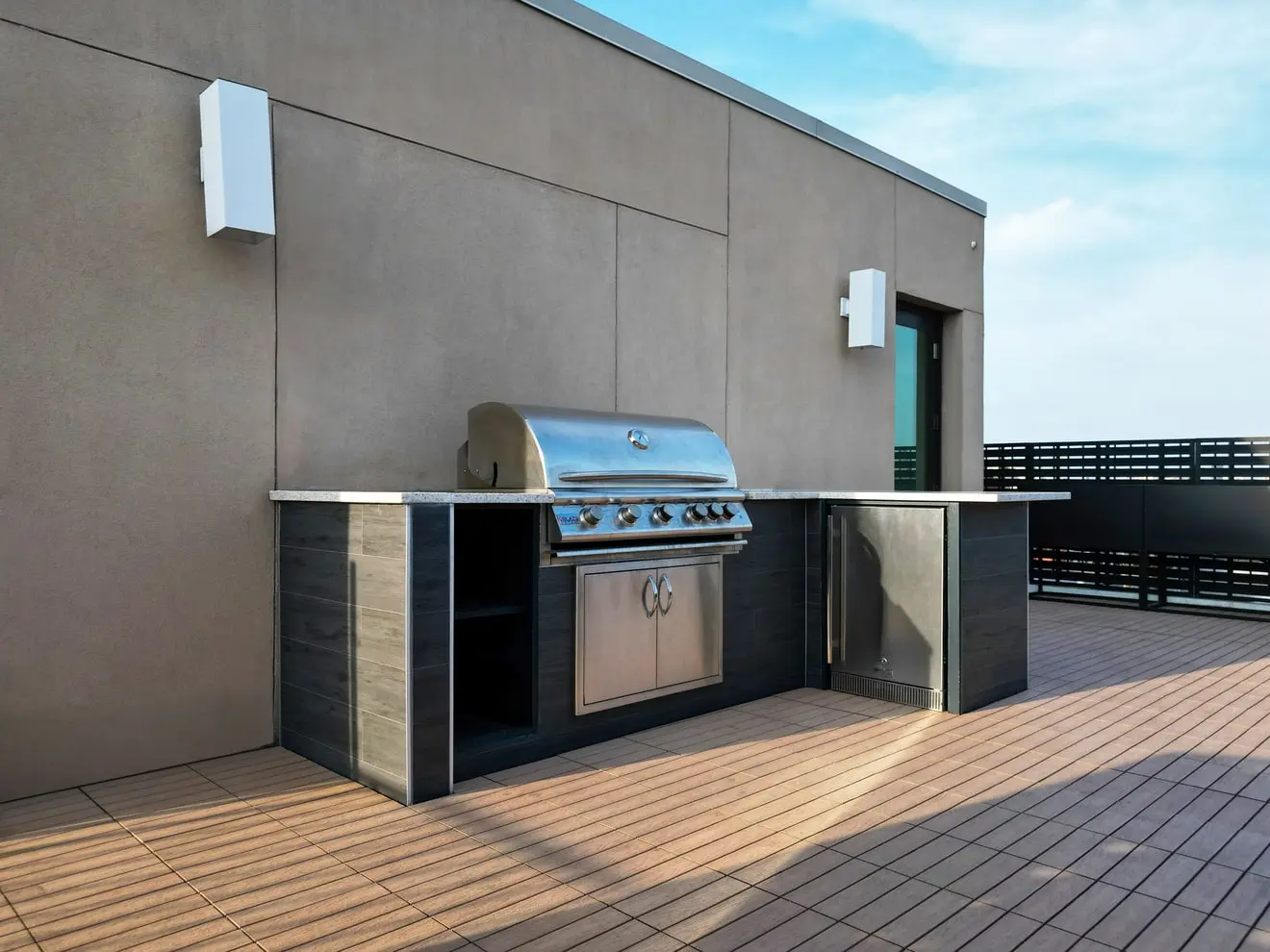 Close-up view of the natural gas outdoor kitchen on a Greenpoint rooftop deck with tile cladding and composite flooring.