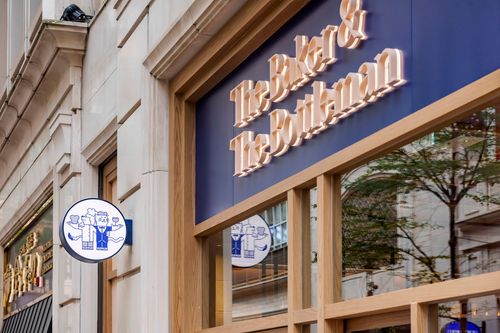 Large bed with chandelier above in bright room