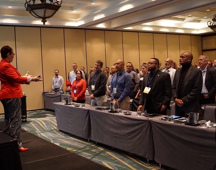 Mitch Savoie Hill facilitating a workshop with a standing audience
