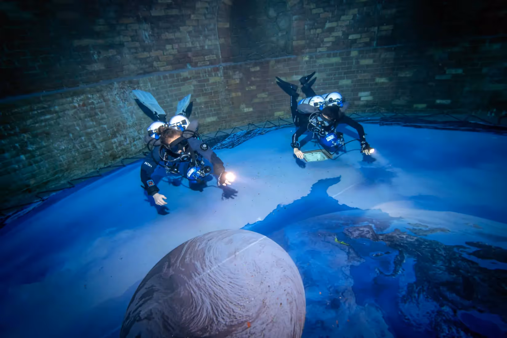 a group of people in scuba gear underwater