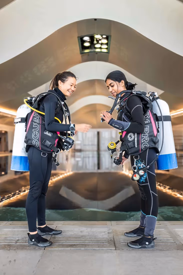 two women wearing scuba gear