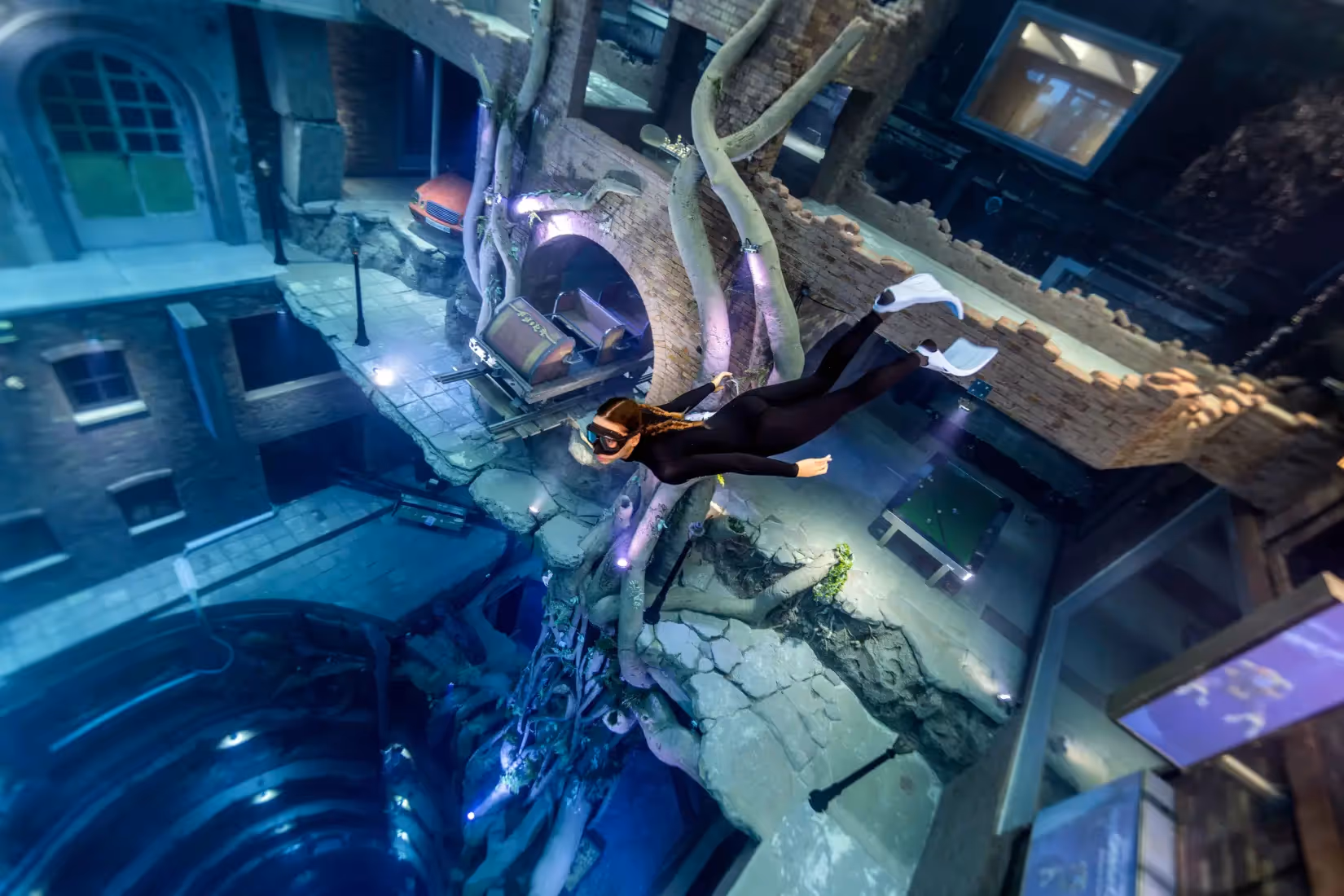 a person in a diving suit and mask floating in a building