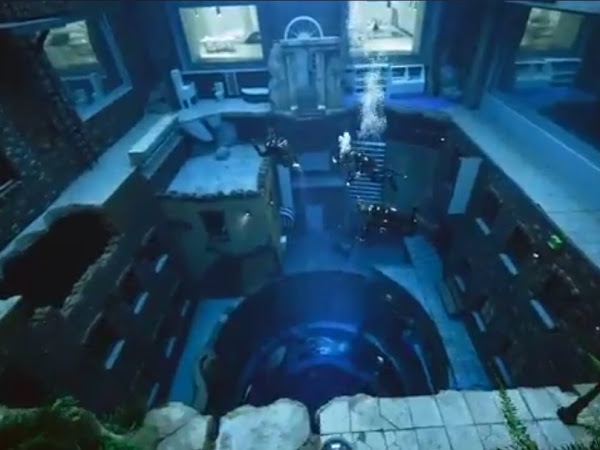 Underwater room resembling a sunken living space with windows and furniture visible.