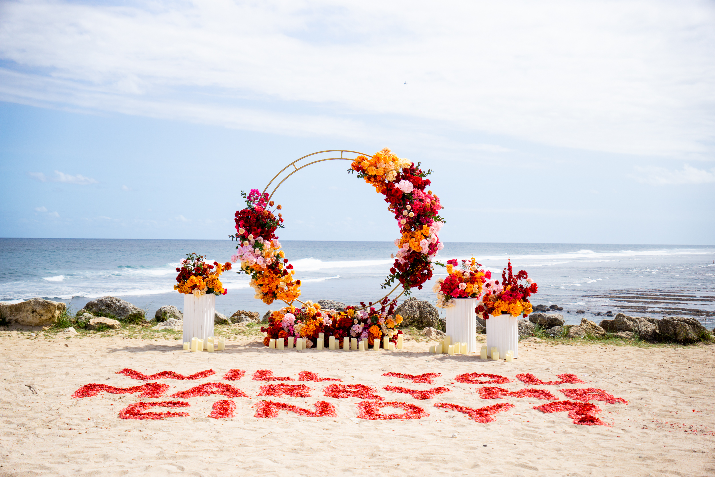 Custom luxury floral proposal arch set up on a secluded Bali cliffside.