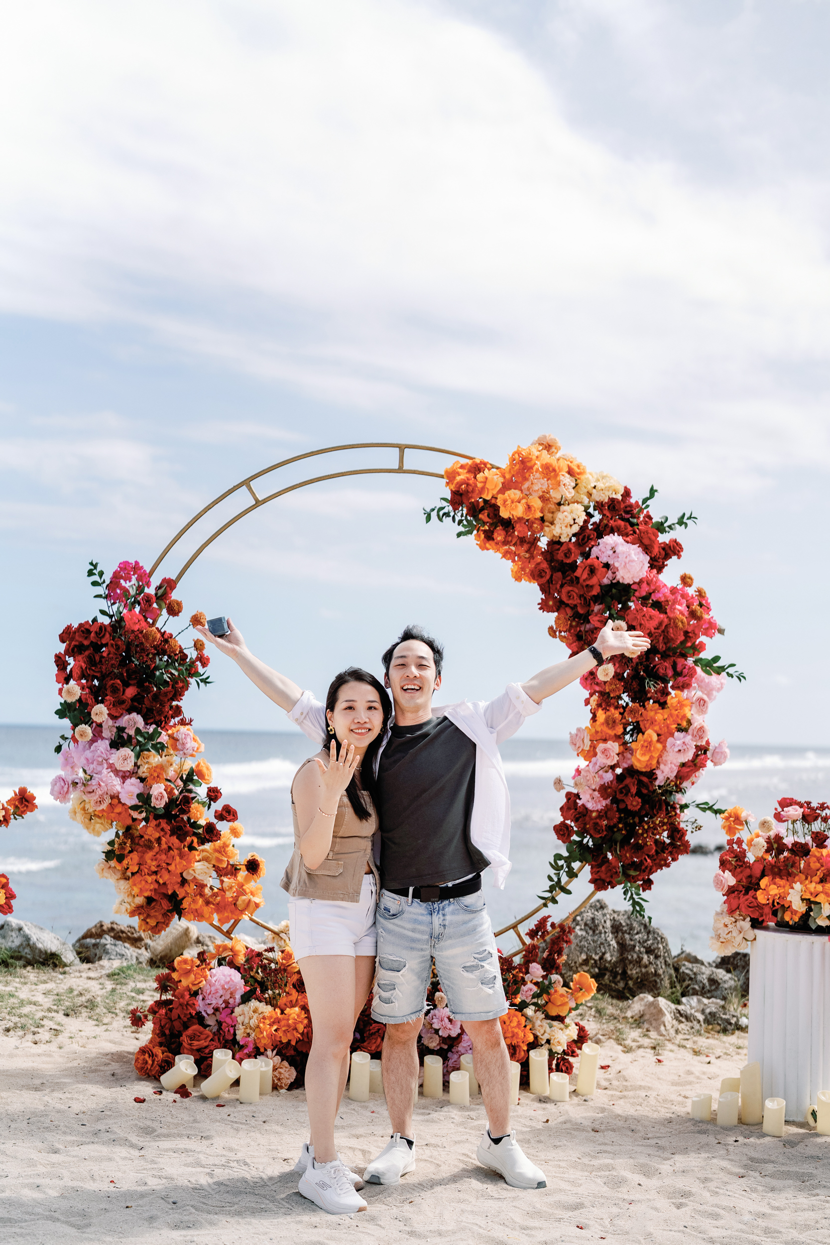 Groom dropping to one knee for a surprise helicopter proposal on a private Bali cliffside.