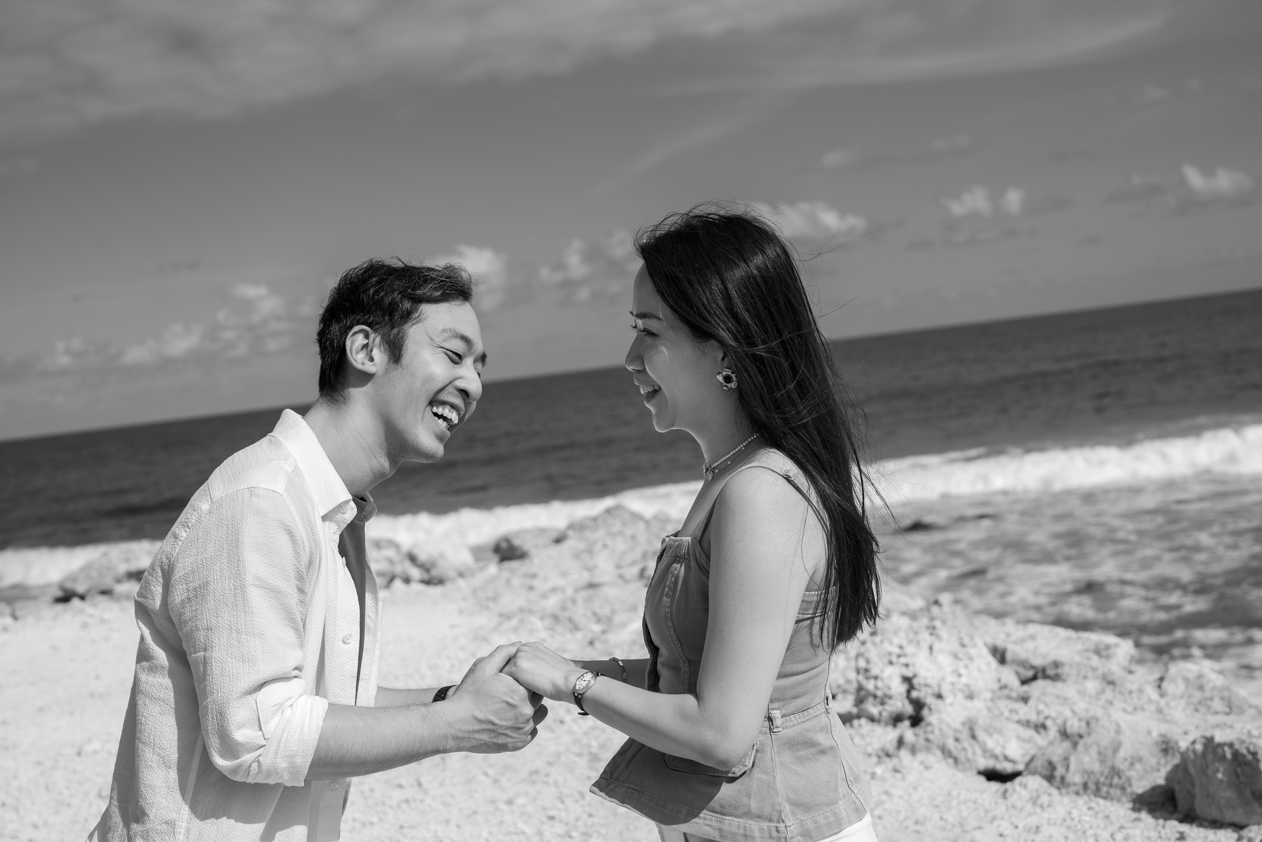 Newly engaged couple hugging in the sunlight during their private proposal photoshoot in Bali.