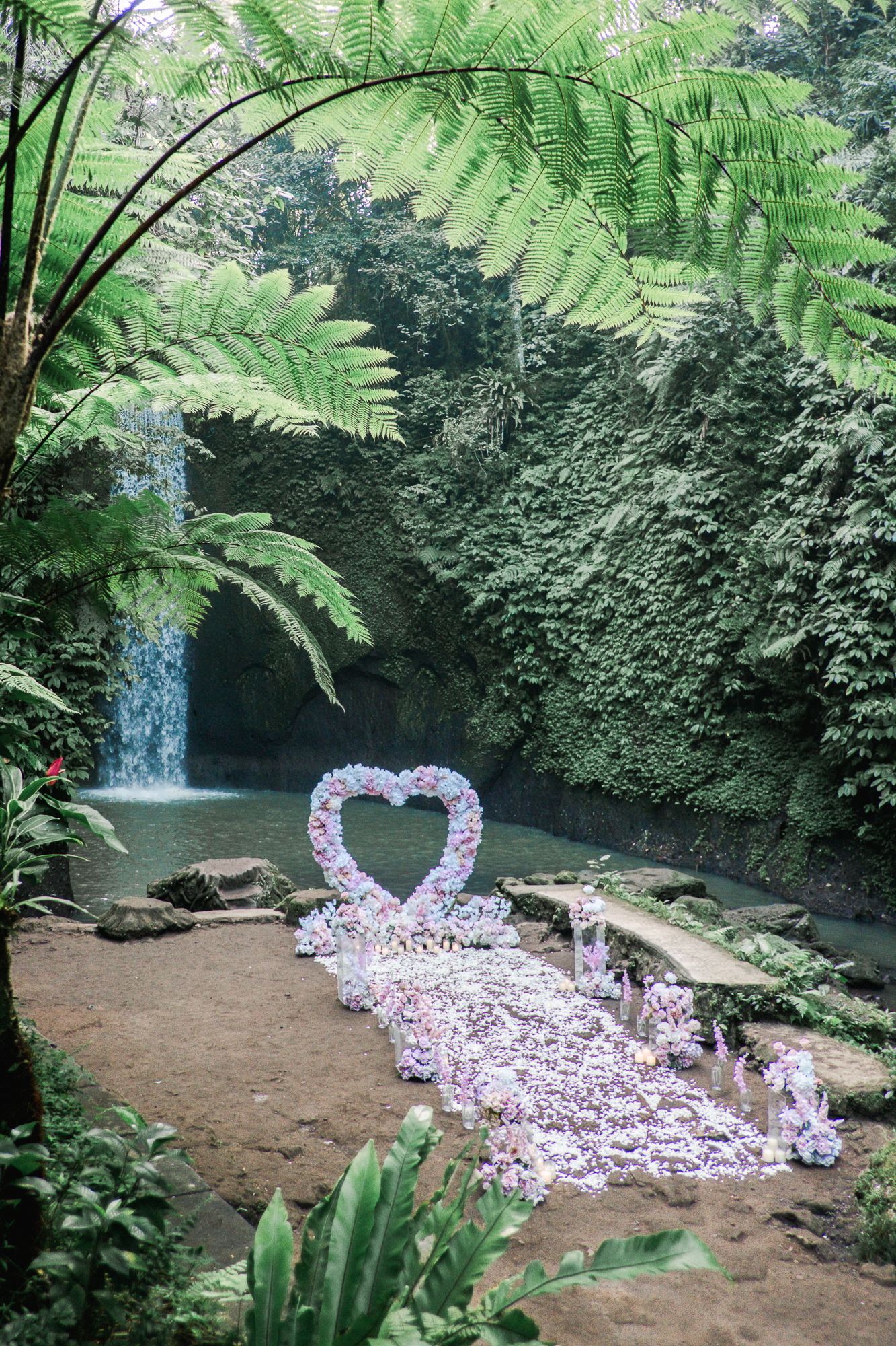 Custom luxury floral proposal arch set up on a secluded Bali cliffside.