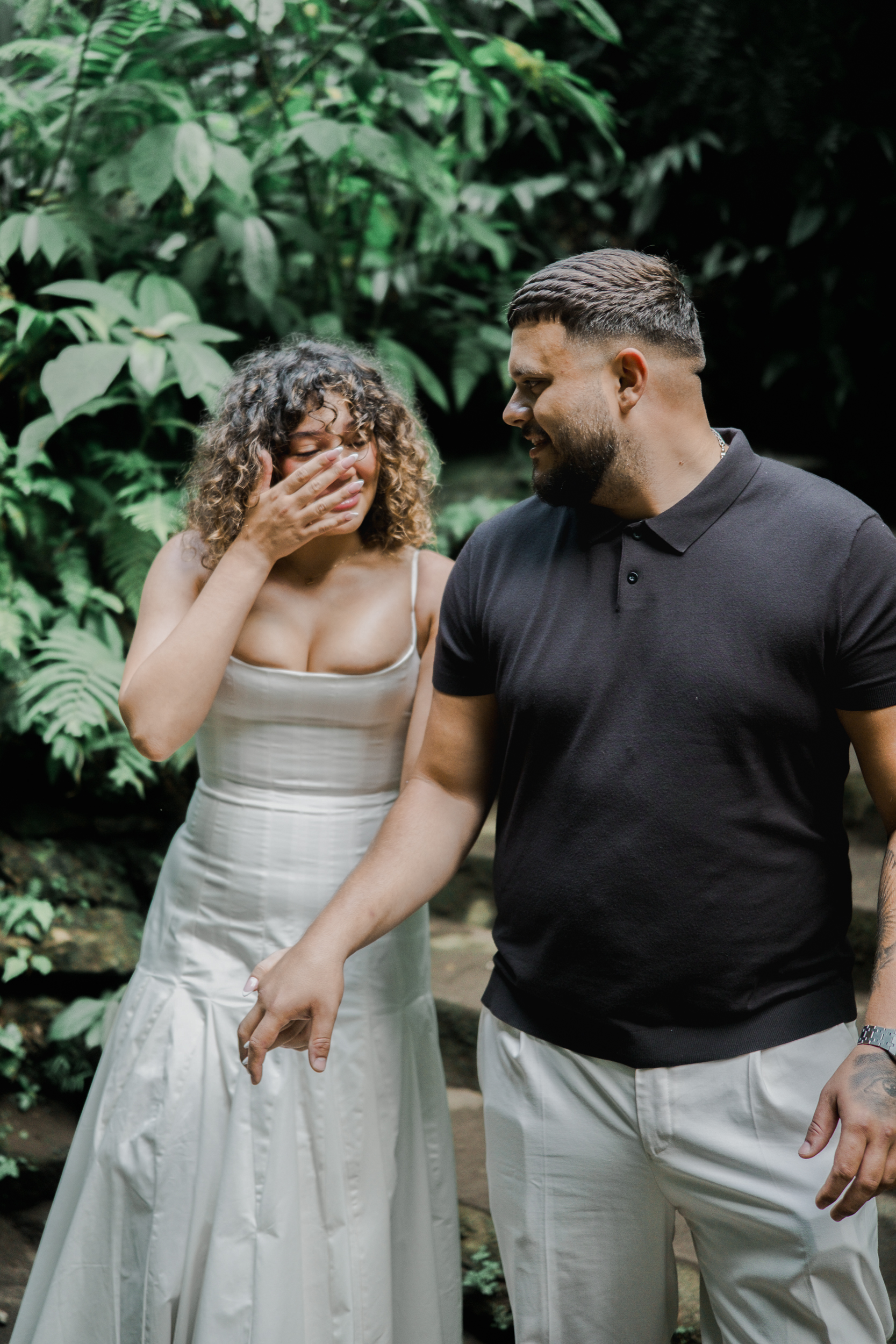 Groom leading his girlfriend away from a landed helicopter during a surprise Bali proposal