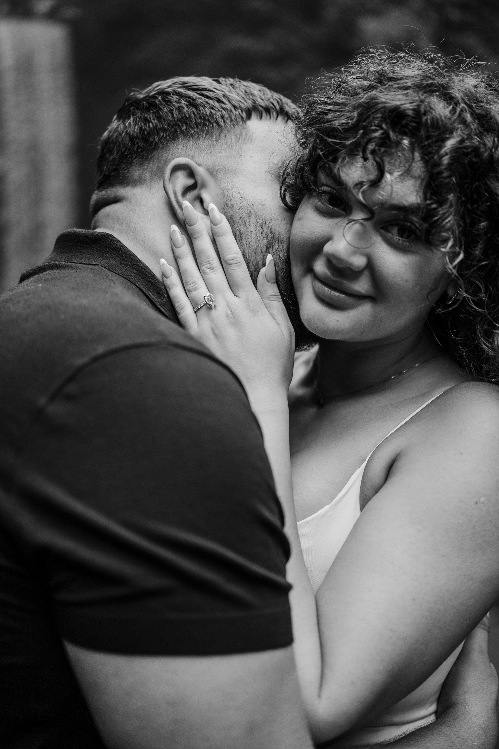 Newly engaged couple hugging in the sunlight during their private proposal photoshoot in Bali.