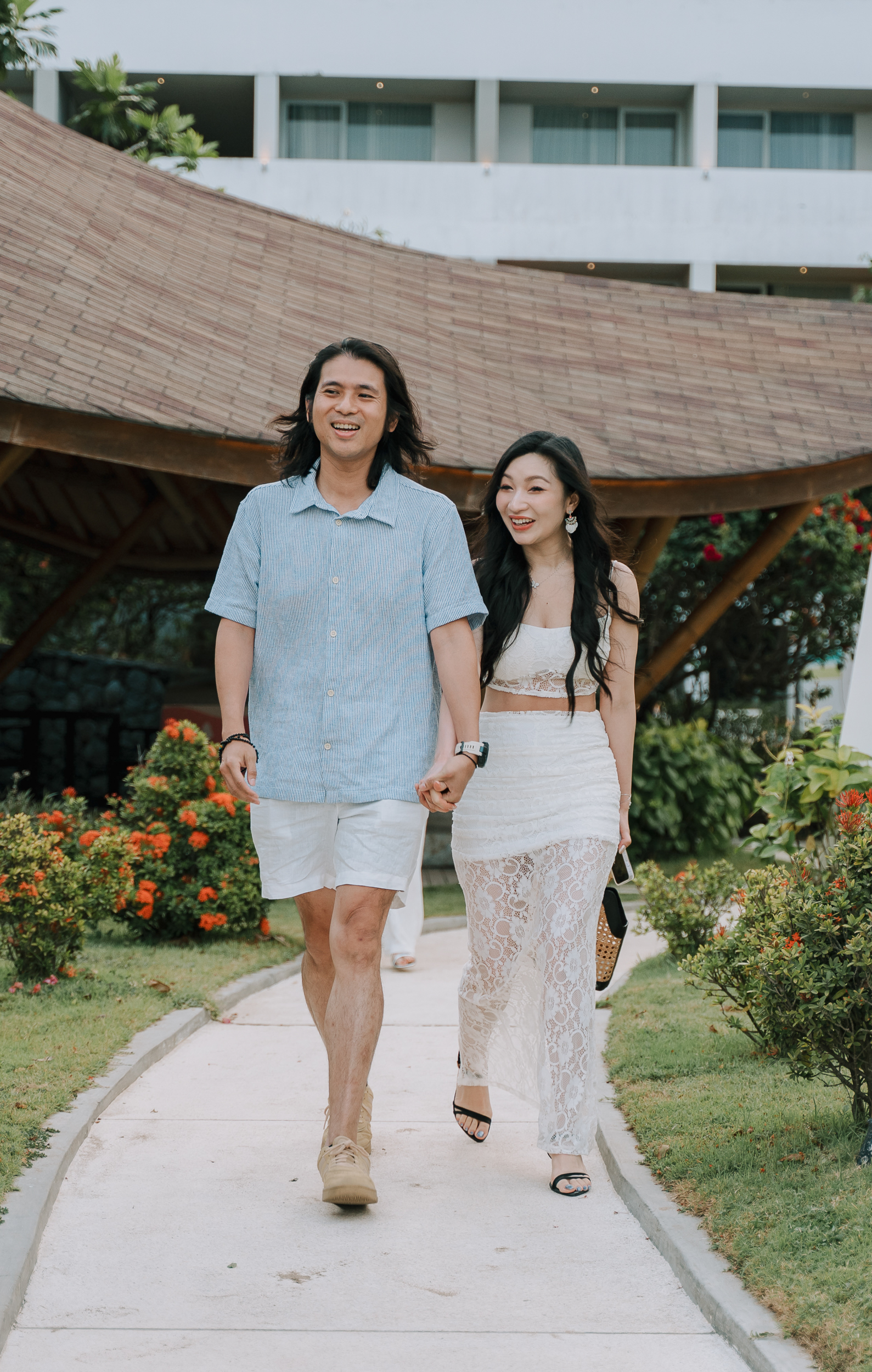 Groom leading his girlfriend away from a landed helicopter during a surprise Bali proposal