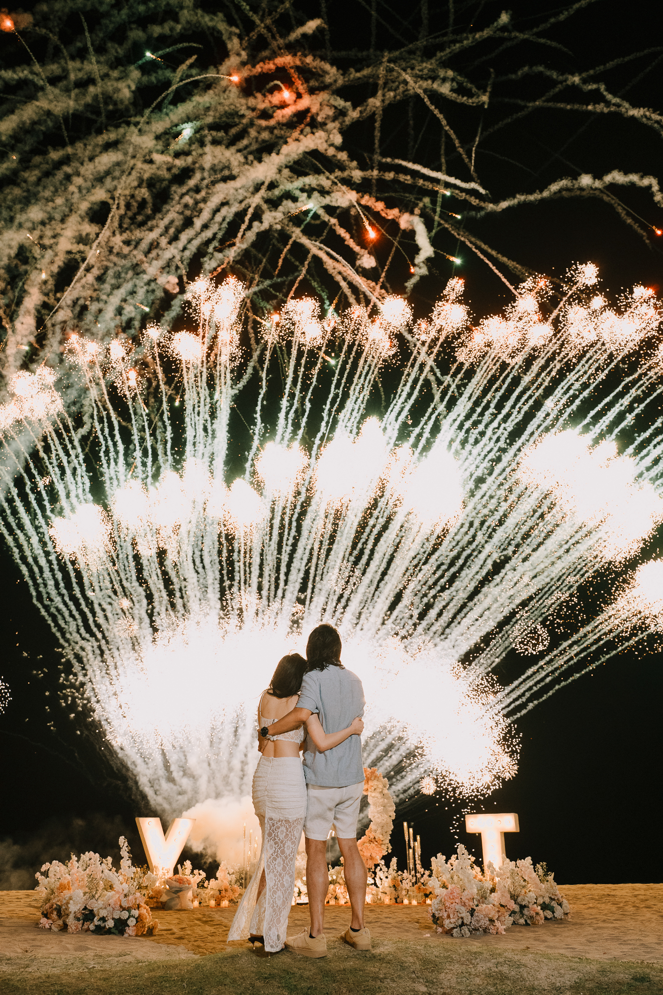 Newly engaged couple hugging in the sunlight during their private proposal photoshoot in Bali.