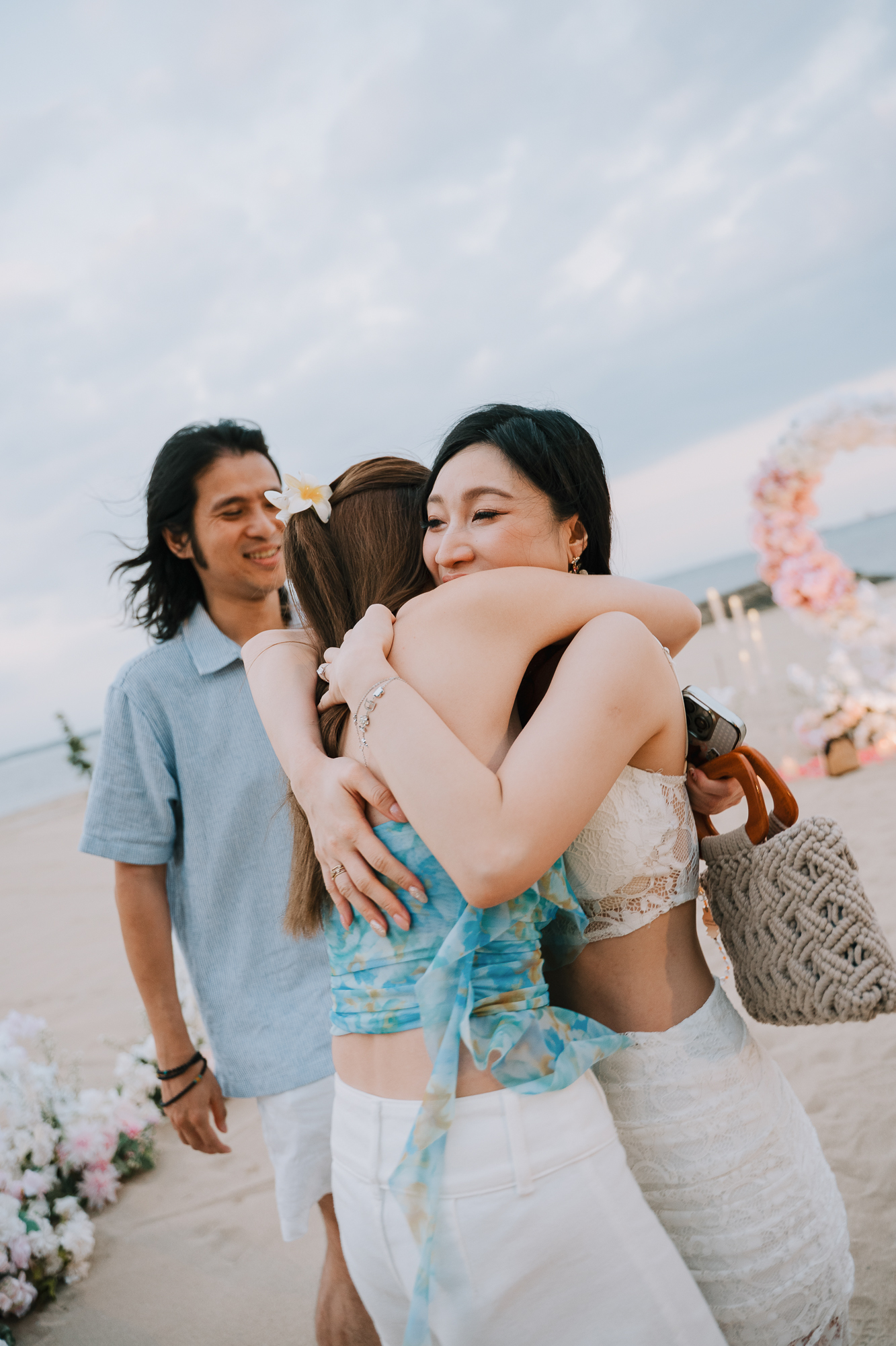 oman embracing a friend in a joyful hug on the beach after the proposal