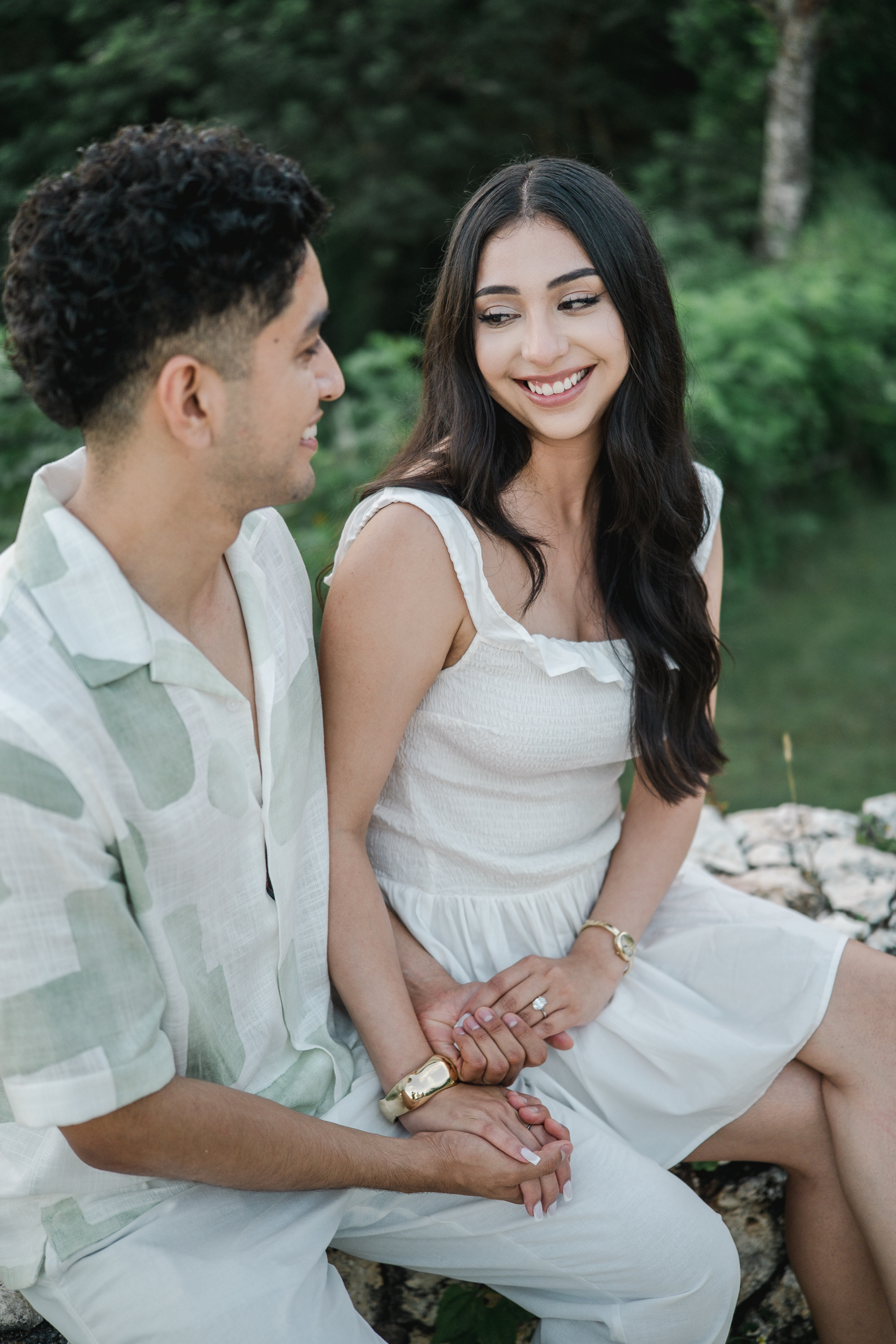 Close-up portrait of couple holding hands showing diamond engagement ring