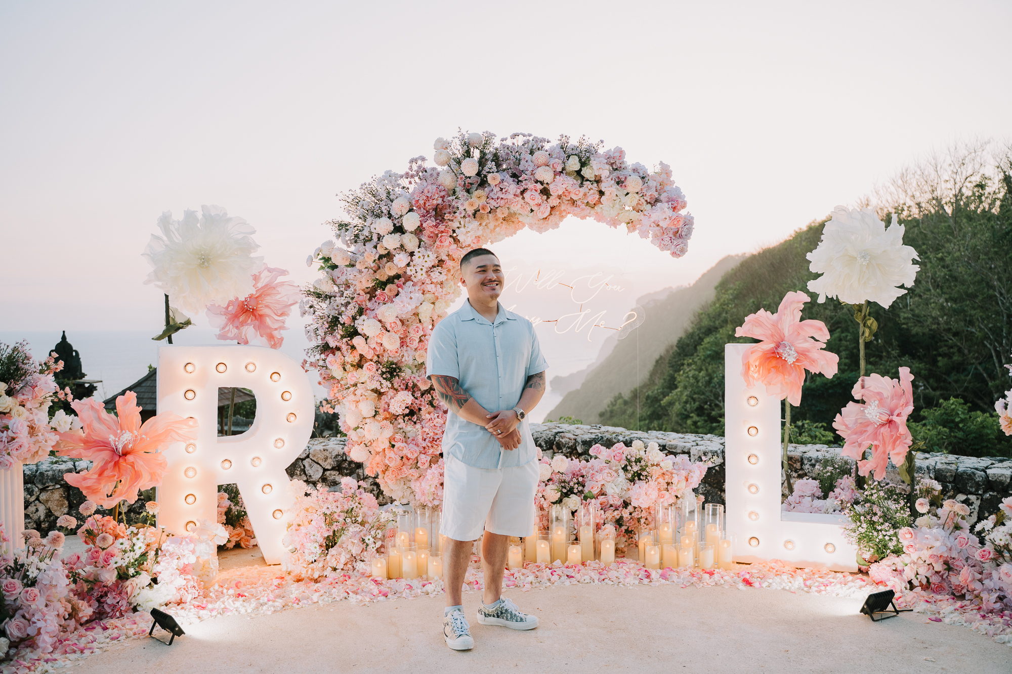 Groom-to-be waiting at the cliffside proposal venue prior to the surprise reveal