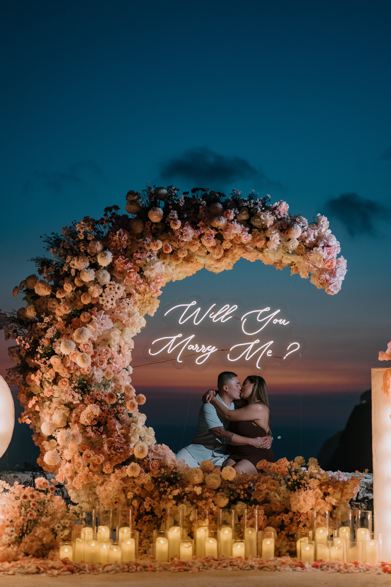 Newly engaged couple hugging in the sunlight during their private proposal photoshoot in Bali.