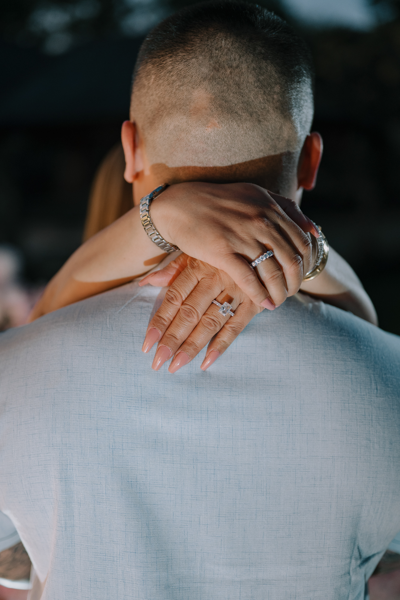 Macro close-up of a diamond engagement ring during an embrace following an Uluwatu proposal