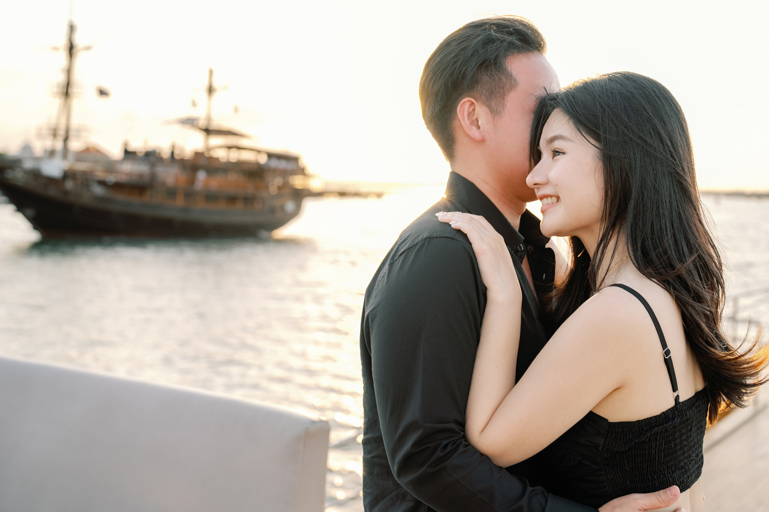 Candid photography of a happy couple on a private boat during a bespoke Bali surprise proposal.