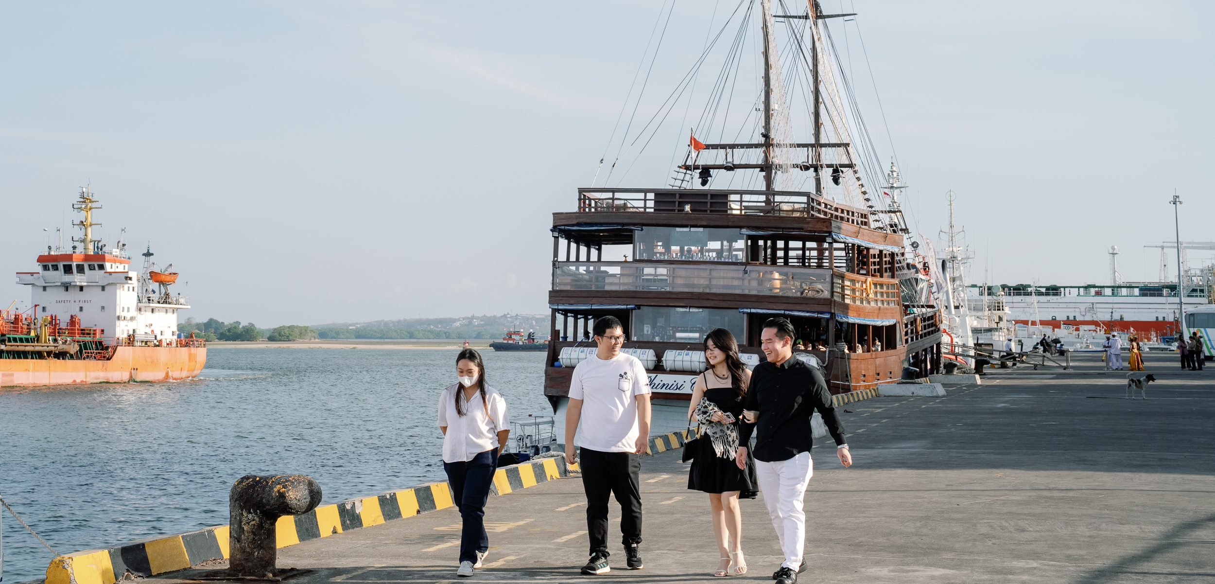 Couple arriving at the harbor for a covert luxury Bali yacht proposal, meticulously orchestrated by a premier Bali proposal planner.