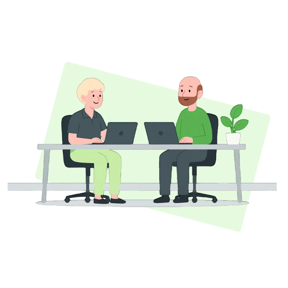Zwei Personen sitzen an einem Tisch und arbeiten an Laptops, vor grünem Hintergrund mit Pflanze.