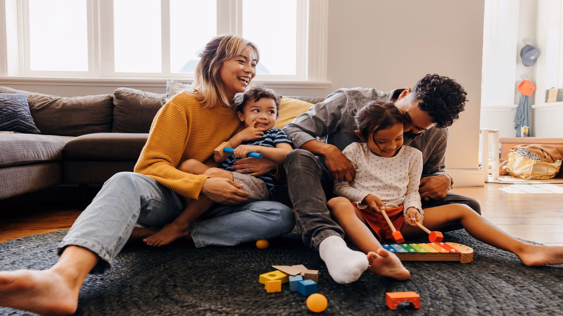 Family of four enjoying playtime at home 