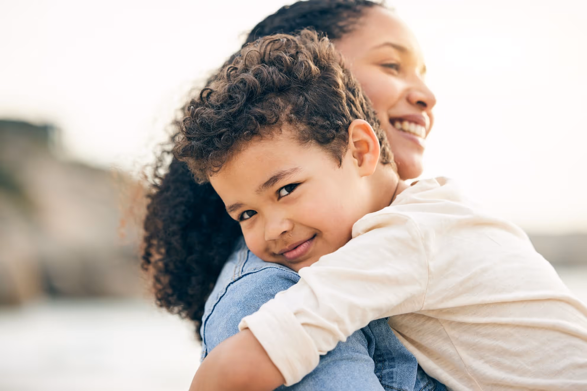 A mother and young child enjoy quality outdoor time together, highlighting nurturing care and joyful moments, essential for happy family relationships in nanny care scenarios.