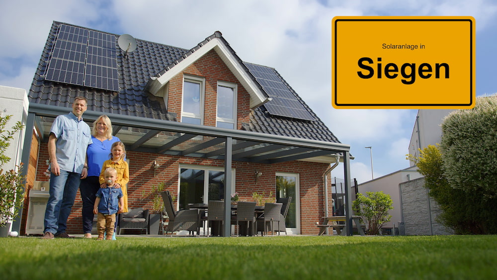 Familie vor Haus mit Solaranlage und Ortsschild von Siegen