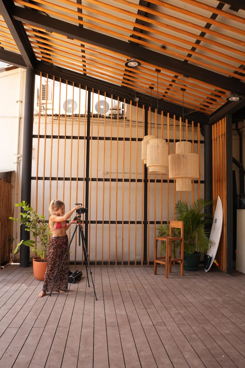 Social Scene creative setting up a camera on a tripod during a behind-the-scenes content shoot in Costa Rica
